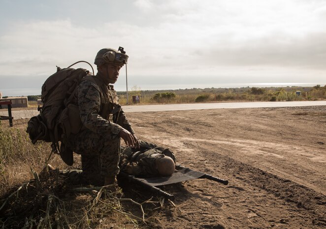 A U.S. Marine provides first aid to a notionally downed pilot during a Tactical Recovery of Aircraft and Personnel Certification on Marine Corps Base Camp Pendleton, Calif., Aug. 4.