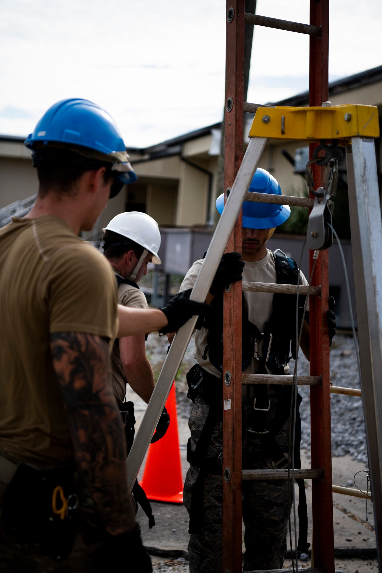U.S. Air Force Senior Airman Trent Olson, left, Airman 1st Class Emmanuel Jackson-Wilson, right, cable antenna systems technicians with the 85th Engineering Installation Squadron assigned to Keesler Air Force Base, Mississippi, help Staff Sgt. Jesse Laclair, center, 85th EIS cable antenna systems technician, exit a manhole at Tyndall Air Force Base, Florida, Aug. 28, 2020. The 85th EIS is assisting the 325th Communications Squadron to move information transfer nodes from damaged buildings, which will improve network stability. (U.S. Air Force photo by Tech. Sgt. Clayton Lenhardt)
