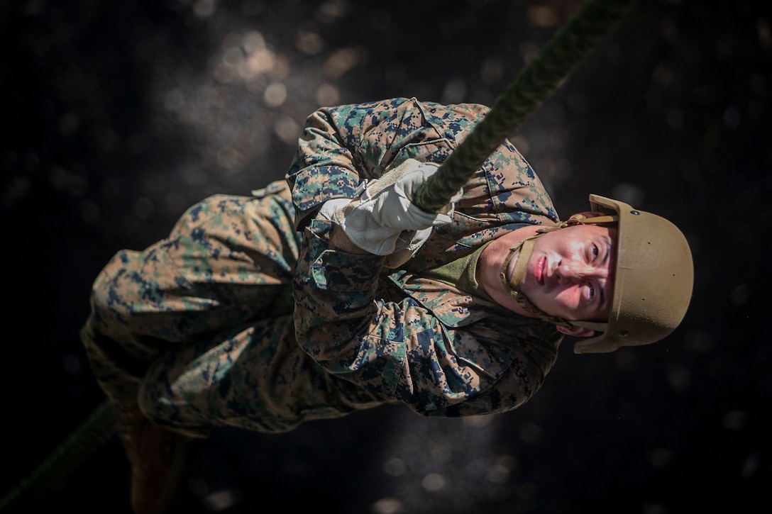 A U.S. Marine conducts a fast roping exercise at the Lightning Academy, East Range Training Complex, Hawaii, Aug. 11.