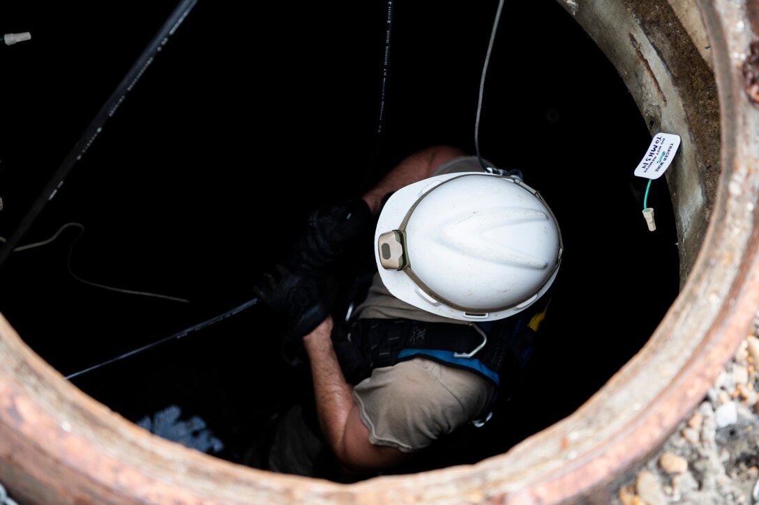 U.S. Air Force Staff Sgt. Jesse Laclair, cable antenna systems technician with the 85th Engineering Installation Squadron assigned to Keesler Air Force Base, Mississippi, pulls cable at Tyndall Air Force Base, Florida, Aug. 28, 2020. The 85th EIS is assisting the 325th Communications Squadron to move information transfer nodes from damaged buildings, which will improve network stability. (U.S. Air Force photo by Tech. Sgt. Clayton Lenhardt)