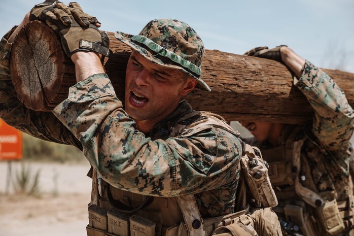 U.S. Marines carry a log as part of the six mile log run during the Supersquad Competition at Marine Corps Base Camp Pendleton, Calif., Aug. 16.