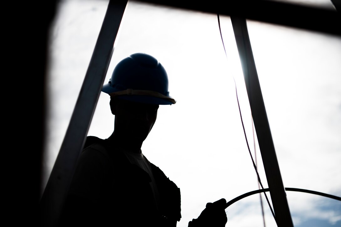 U.S. Air Force Airman 1st Class Emmanuel Jackson-Wilson, cable antenna systems technician with the 85th Engineering Installation Squadron out of Keesler Air Force Base, Mississippi, sorts cable at Tyndall Air Force Base, Florida, Aug. 28, 2020. The 85th EIS has made multiple trips to Tyndall to assist the 325th Communications Squadron with relocating information transfer nodes. (U.S. Air Force photo by Tech. Sgt. Clayton Lenhardt)