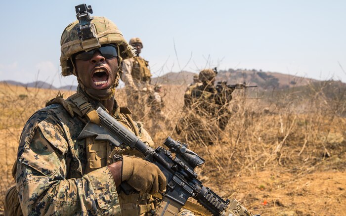 A U.S. Marine relays commands to his fire team while conducting offensive operations during the Supersquad 2020 Competition at Marine Corps Base Camp Pendleton, Calif., Aug. 20.
