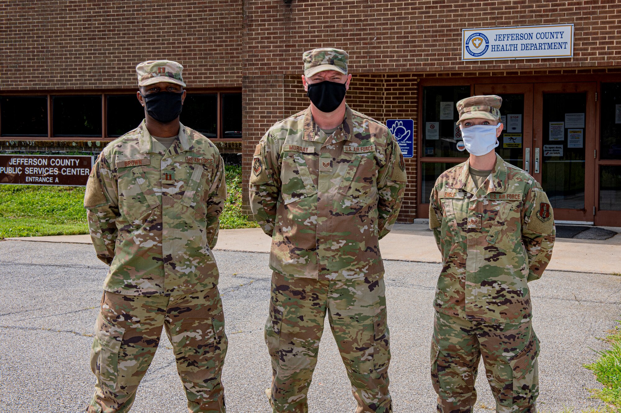 Three members of the 167th Airlift Wing are part of the local COVID-19 case investigation team at the Jefferson County Health Department, Martinsburg, W. Va., Aug. 20, 2020. From left to right, Capt. Rodney Brown, Staff Sgt. James Murray, and Staff Sgt. Erin Engle.  Airmen and civilian volunteers have teamed up to administer contact tracing for the local community. Data gathered from positive and negative tests, phone calls and text messaging are entered into a database where COVID-19 patients and their contacts are tracked.