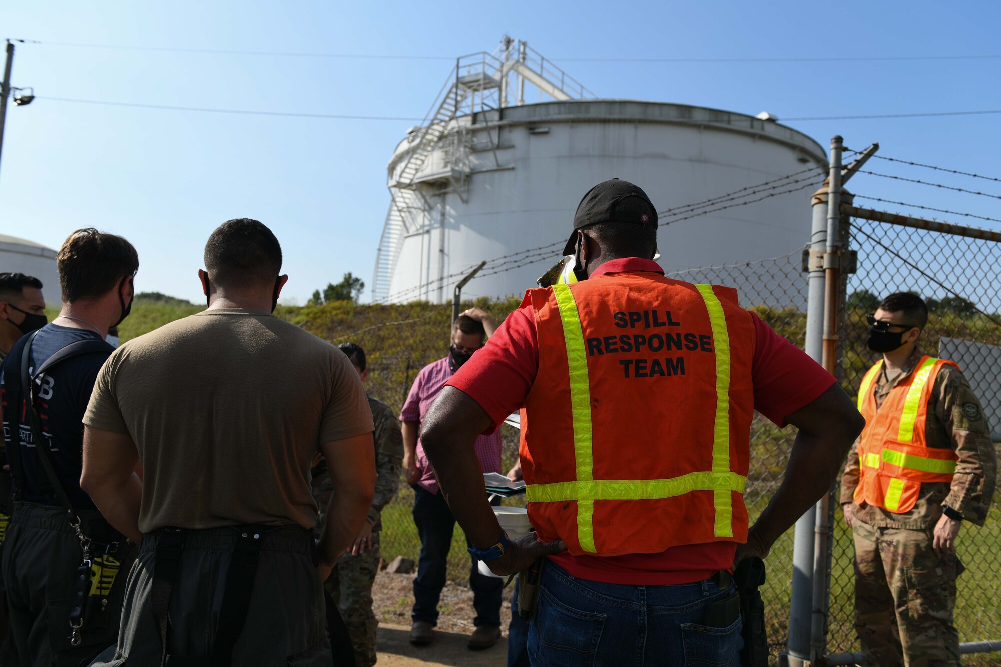 A group of people gather around for a briefing