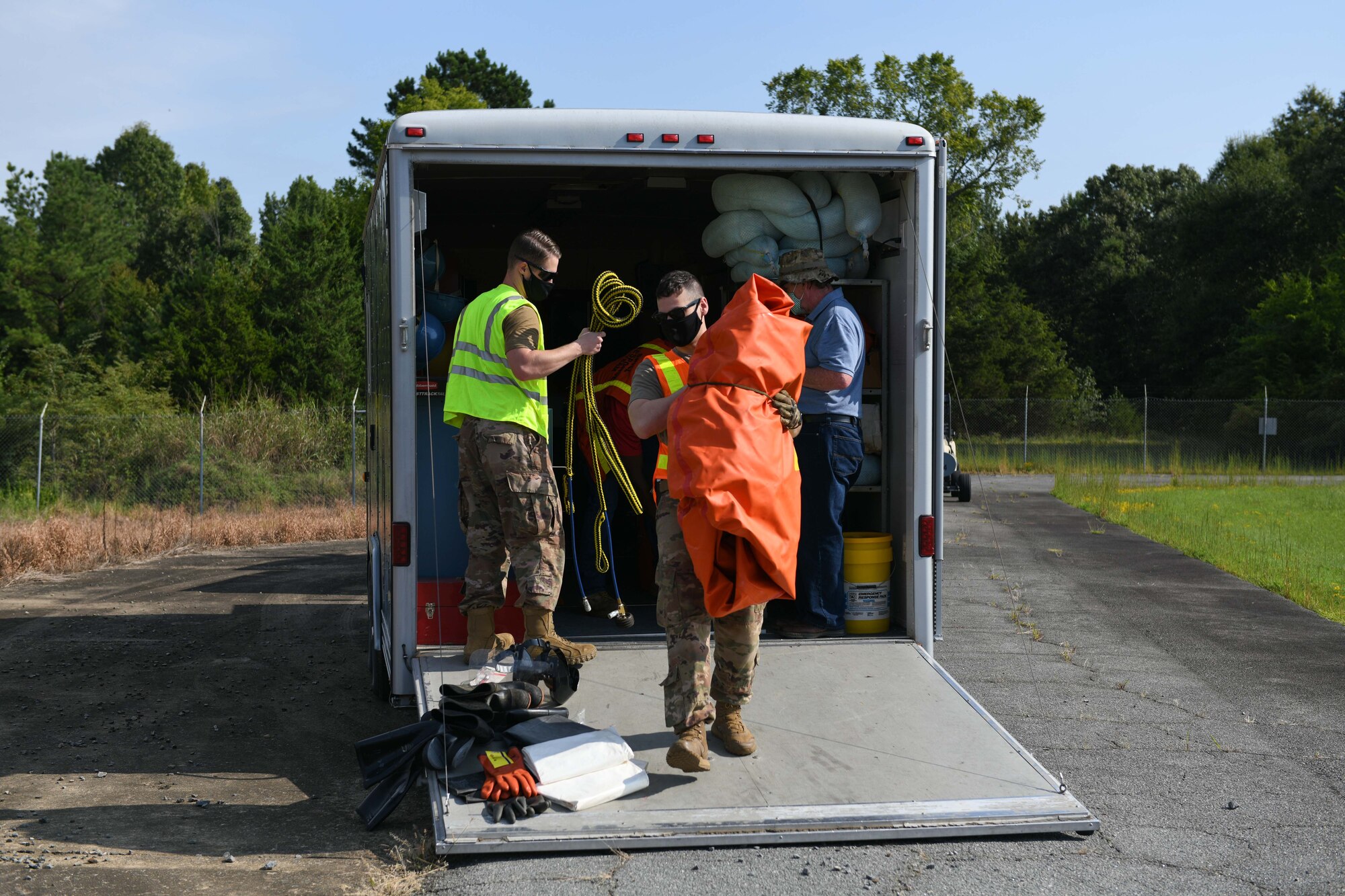 A group of people remove equipment from a vehicle