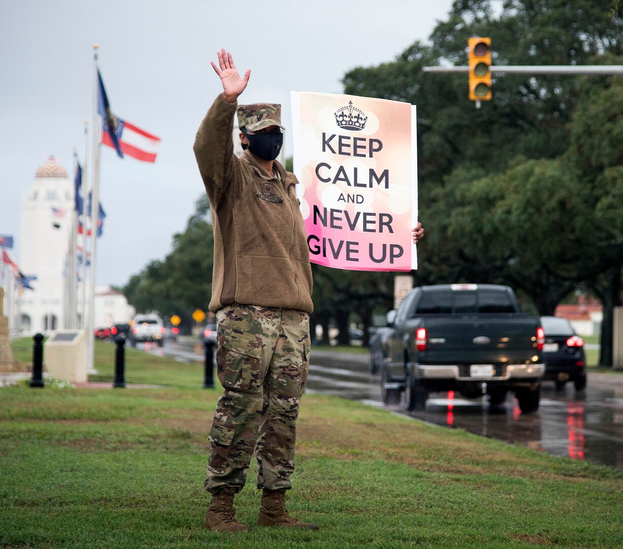 Master Sgt. Tiffany Arrington, 12th Operations Group first sergeant, waves at people driving past her during the “We Care” event at Joint Base San Antonio-Randolph Sept. 10.