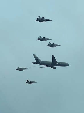 A New Hampshire Air National Guard KC-46A Pegasus refuels five Marine Corp’s F/A-18D Hornets with the Marine All-Weather Fighter Attack Squadron 242, as the fighters returned home to Marine Corps Air Station Yuma, Ariz. from MCAS Iwakuni, Japan on Sept. 10, 2020, over the Pacific Ocean. This marks the first official transoceanic coronet mission ever accomplished with a Pegaus refueler, which began Sept. 9 and involved 16 aerial refuelings of the fighters. (courtesy photo)