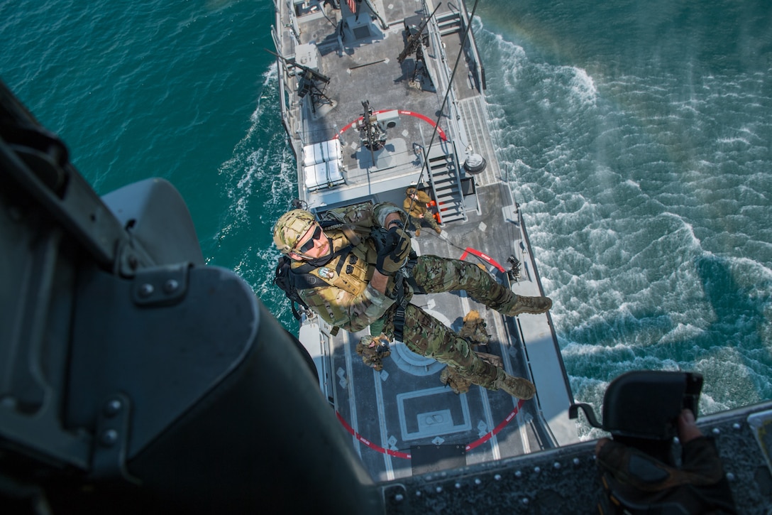 An explosive ordnance disposal technician conducts hoist training operations in the Arabian Gulf.