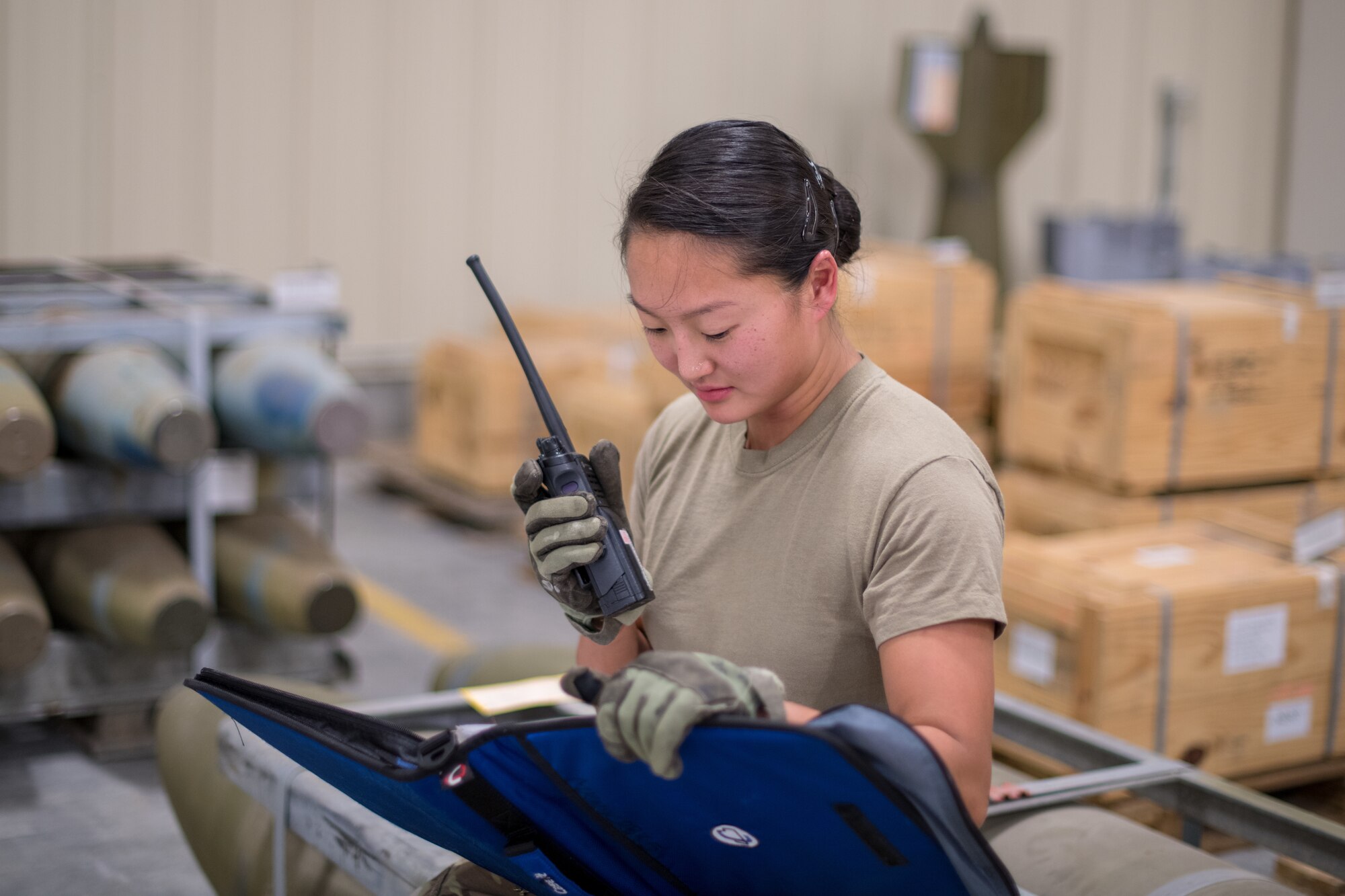 Senior Airman Marian Bock, 22nd Maintenance Squadron munitions flight custody accounts technician, radios in ammunition inspection results Aug. 28, 2020, at McConnell Air Force Base, Kansas. Munitions flight’s primary duty at McConnell is to store, inspect and account for the base’s entire arsenal. (U.S. Air Force photo by Senior Airman Skyler Combs)