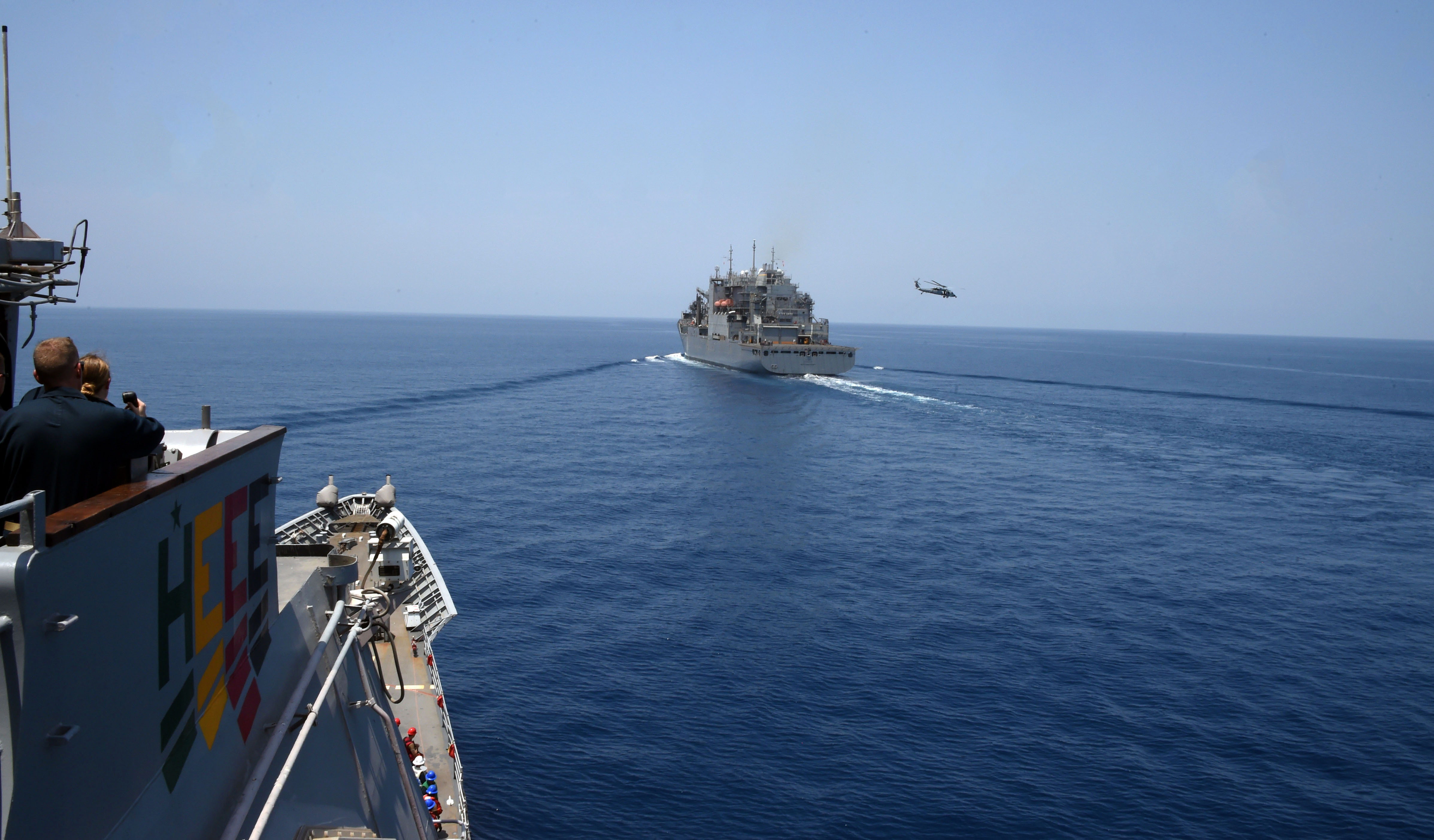 The guided-missile cruiser USS Philippine Sea (CG 58) approaches the Military Sealift Command dry cargo and ammunition ship USNS Matthew Perry (T-AKE 9) during a vertical replenishment-at-sea.