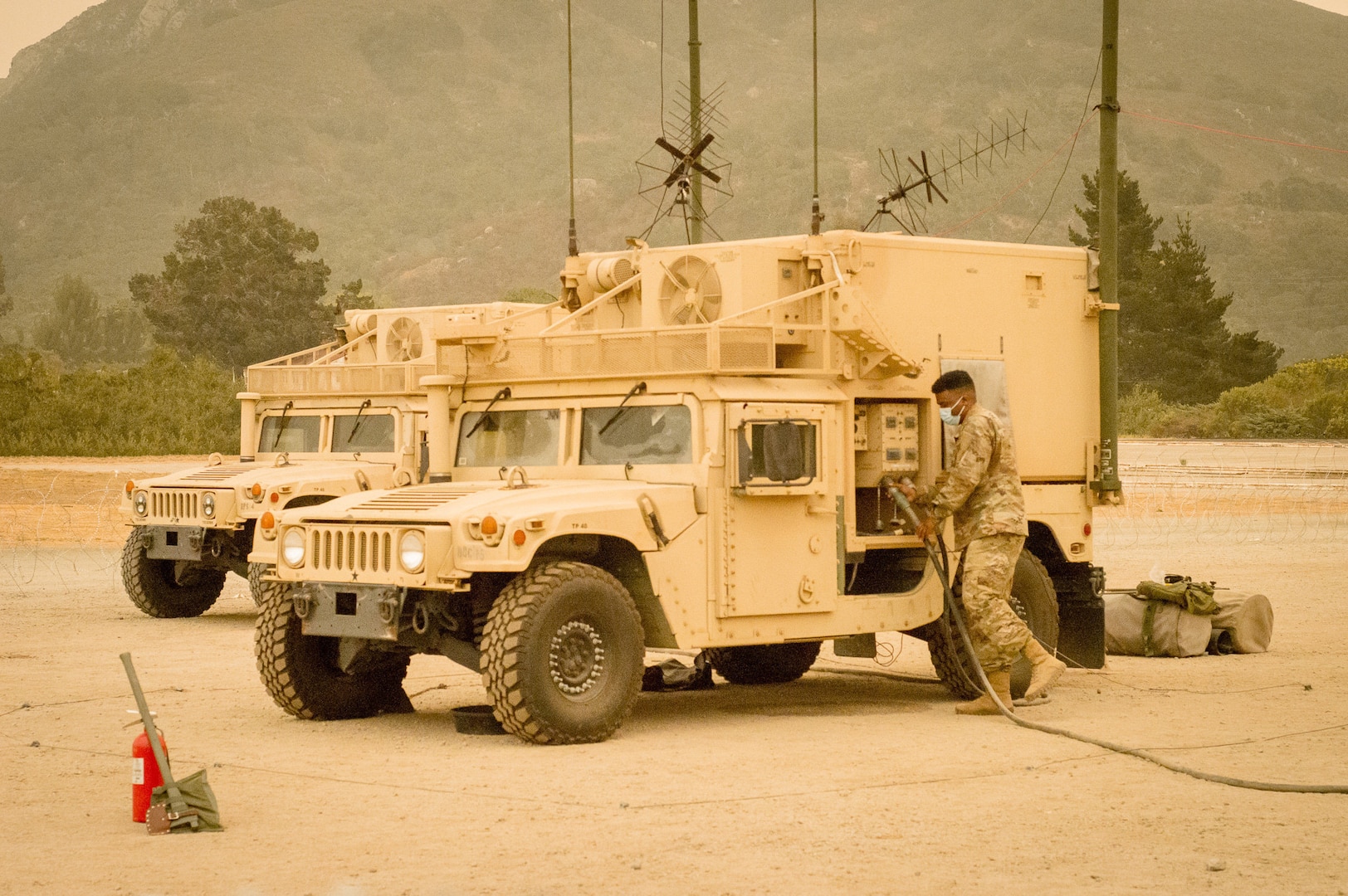 U.S. Army Spc. Jonathan Carpenter, assigned to Cal Guard’s 40th Infantry Division, installs cables to the command post platform to connect power from the generators at Camp San Luis Obispo, California, Aug. 30, 2020, during Defender Pacific 20. The ability to rapidly surge combat-ready forces into and across the theater is critical in projecting forces at a moment’s notice to support regional alliances and the existing security architecture.