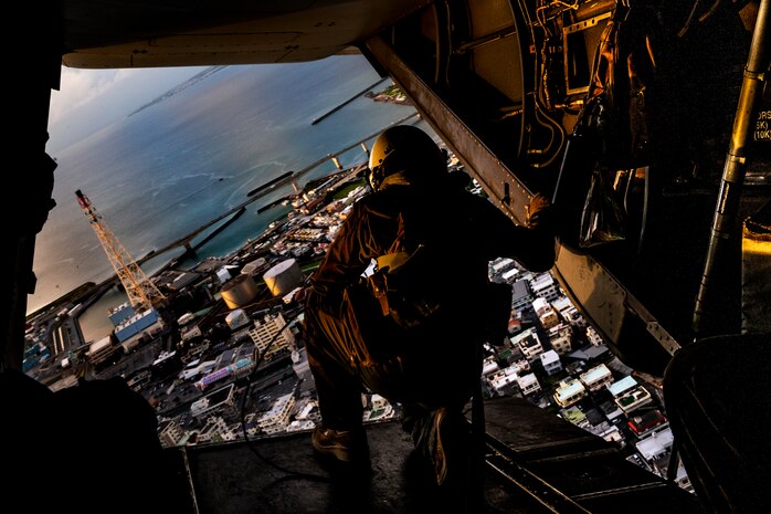 A U.S. Marine flies over Okinawa while aboard an MV-22 Osprey during Operation Lightning Strike, Aug. 6.