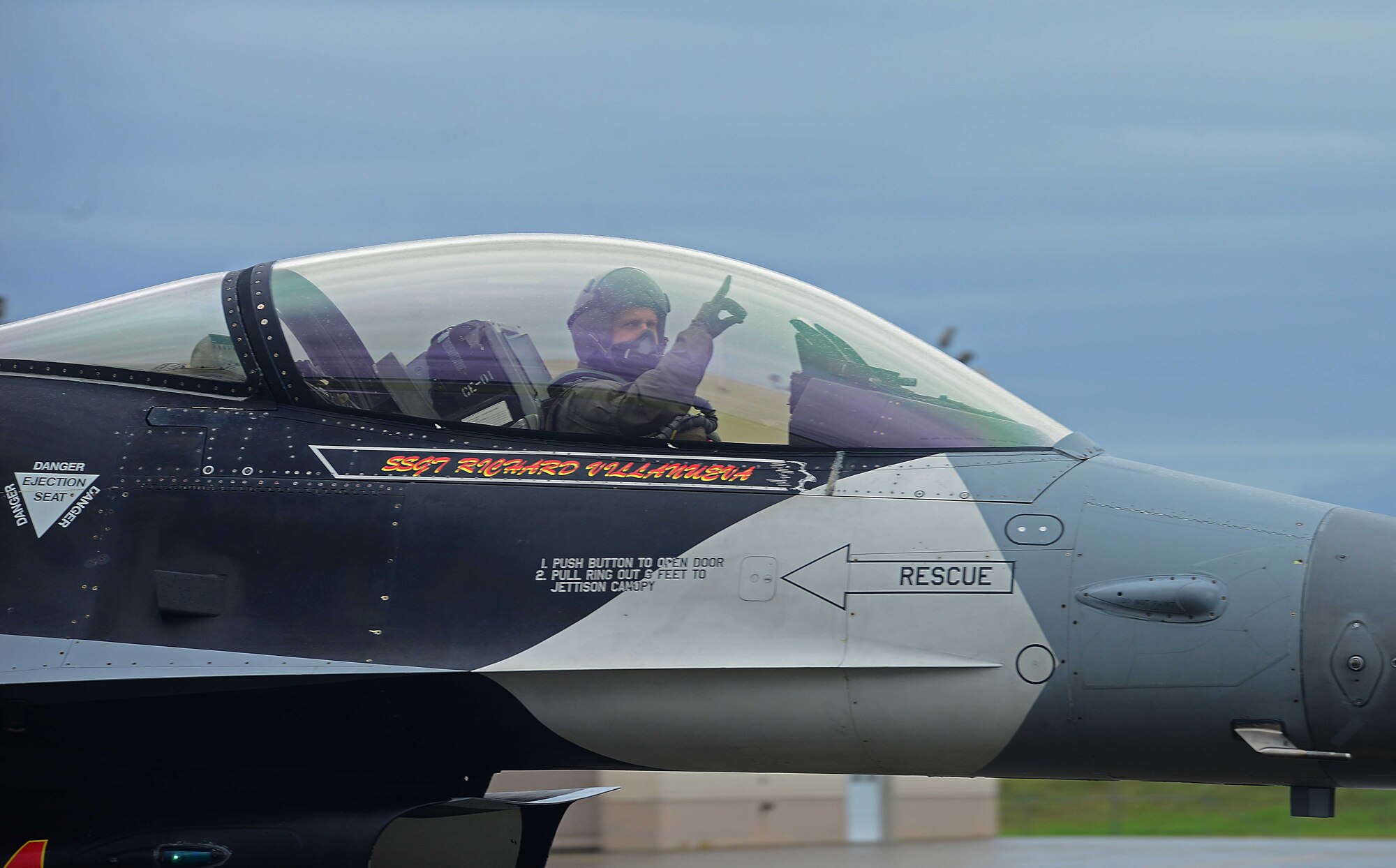 An F-16 Fighting Falcon pilot assigned to the 18th Aggressor Squadron gives a hand signal before takeoff to support exercise Valiant Shield on Eielson Air Force Base, Alaska, Sept. 8, 2020. Valiant Shield is a biennial, U.S.-only field training exercise with a focus on integration of joint training among U.S. forces in relation to current operational plans. Valiant Shield 20 provides an effective, flexible and capabilities centered force, enabling real-world proficiency in response to a variety of crises. (U.S. Air Force photo by Staff Sgt. Sean Martin)