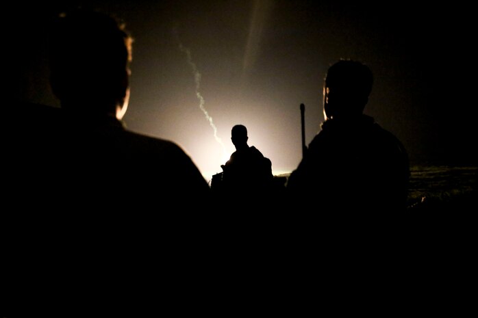 U.S. Marines watch illuminating rounds during a simulated close air support and assault support training event at W-174, Okinawa, Japan, Aug. 18.