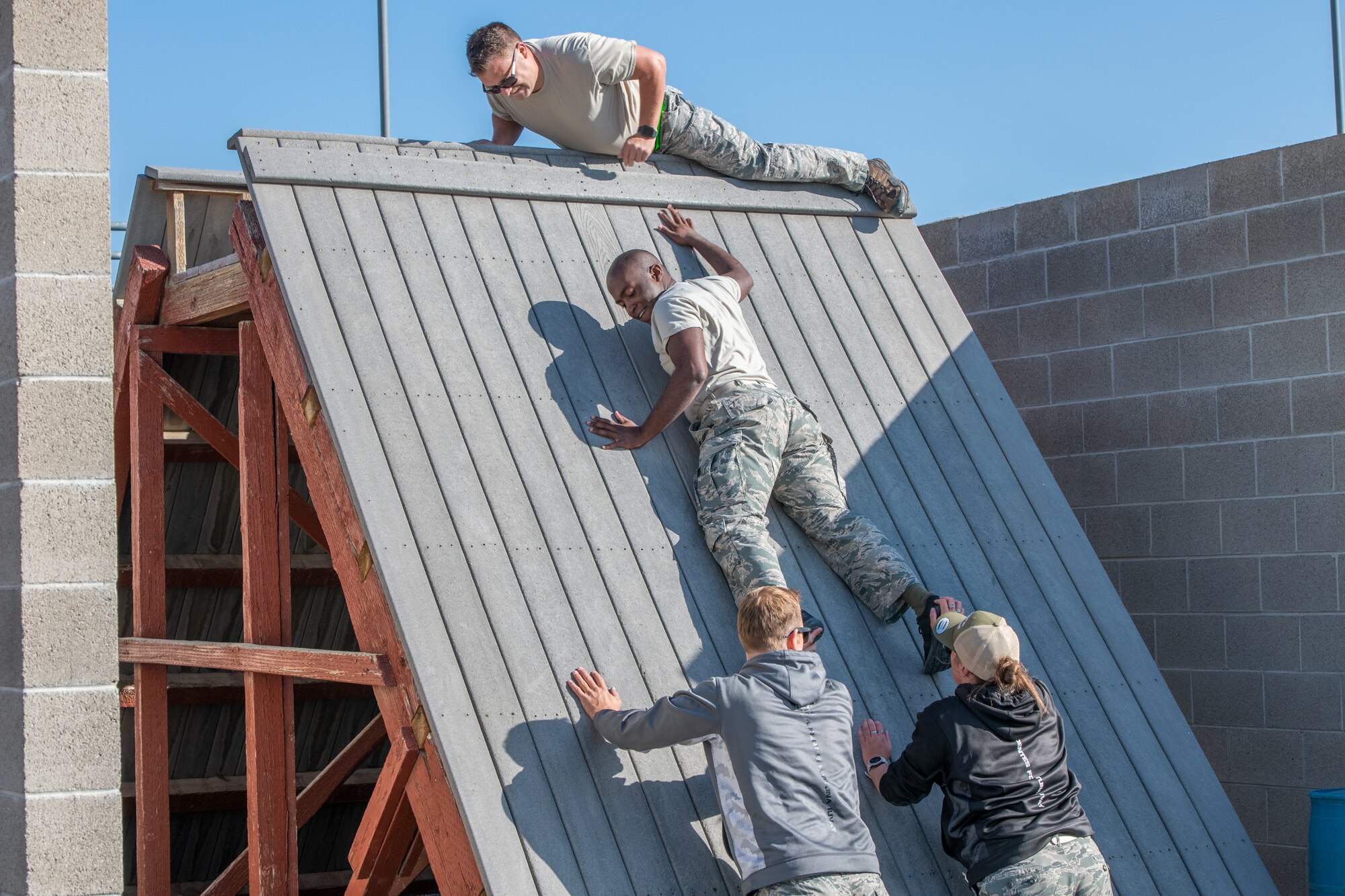 Reservists from the 419th Fighter Wing assist a fellow Airman to complete an obstacle Sept. 11, 2020, at Camp Williams, Utah