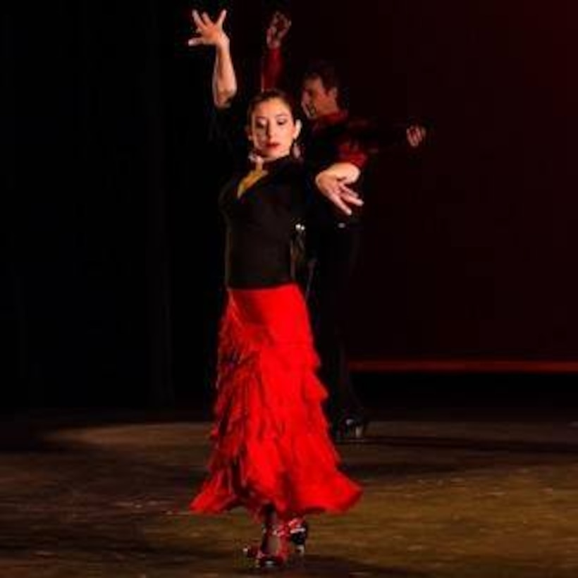 Lady in red dress dancing.