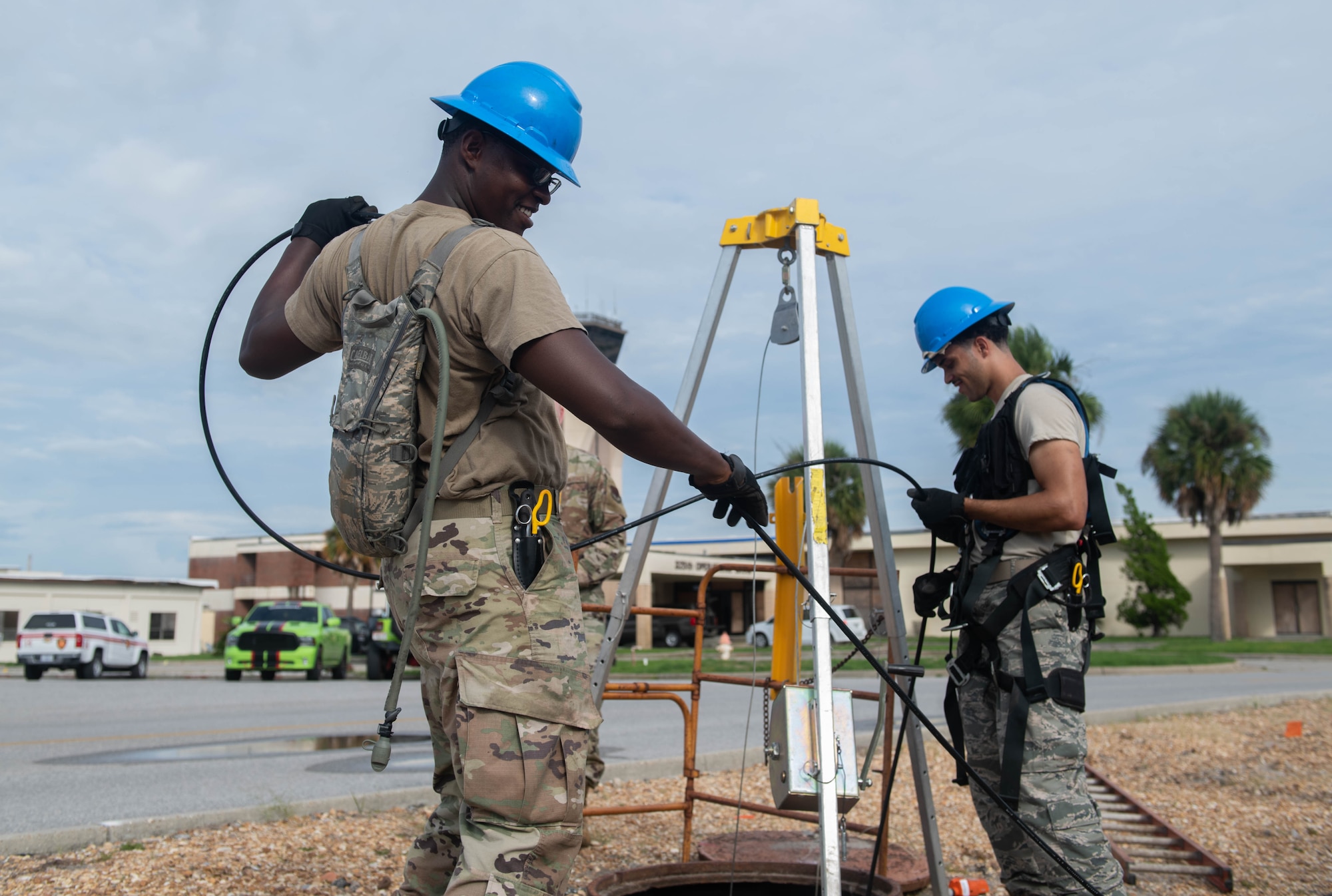 U.S. Air Force Senior Airman Darren Perry, cable antenna systems technician with the 85th Engineering Installation Squadron assigned to Keesler Air Force Base, Mississippi, and Airman 1st Class Emmanuel Jackson-Willson, cable antenna systems technician with the 85th EIS, manage cable at Tyndall Air Force Base, Florida, Aug. 28, 2020. Perry and Jackson-Willson came to Tyndall to help relocate information transfer nodes to improve network connection across base. (U.S. Air Force photo by Airman Anabel Del Valle)