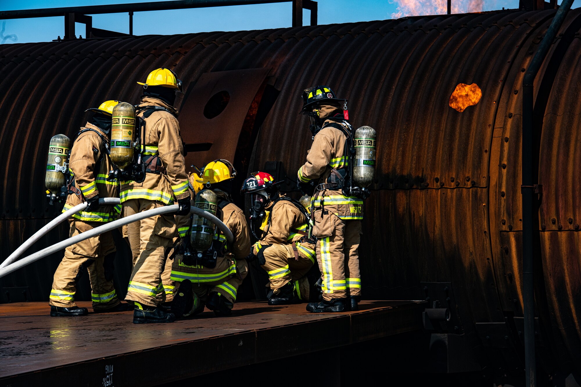 Firefighters from Rickenbacker Air National Guard prepare to breach Youngstown Air Reserve Station’s burn pit, Sept. 9, 2020. About 40 Citizen Airmen from RANG’s fire department came to the 910th Airlift Wing, Sept. 8-10, to do their annual live-fire training.