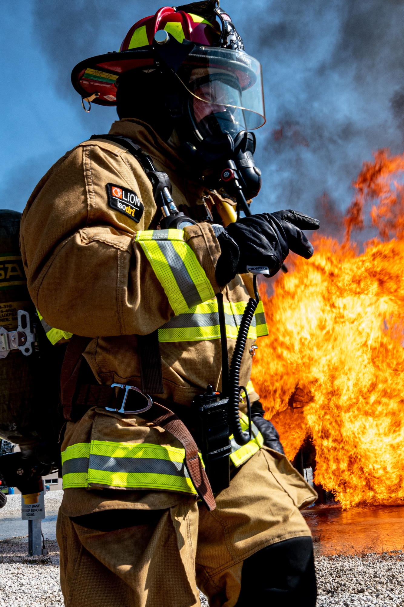 A Rickenbacker Air National Guard firefighter radios commands, Sept. 9, 2020, at Youngstown Air Reserve Station’s burn pit. About 40 Citizen Airmen from RANG’s fire department came to the 910th Airlift Wing, Sept. 8-10, to do their annual live-fire training.