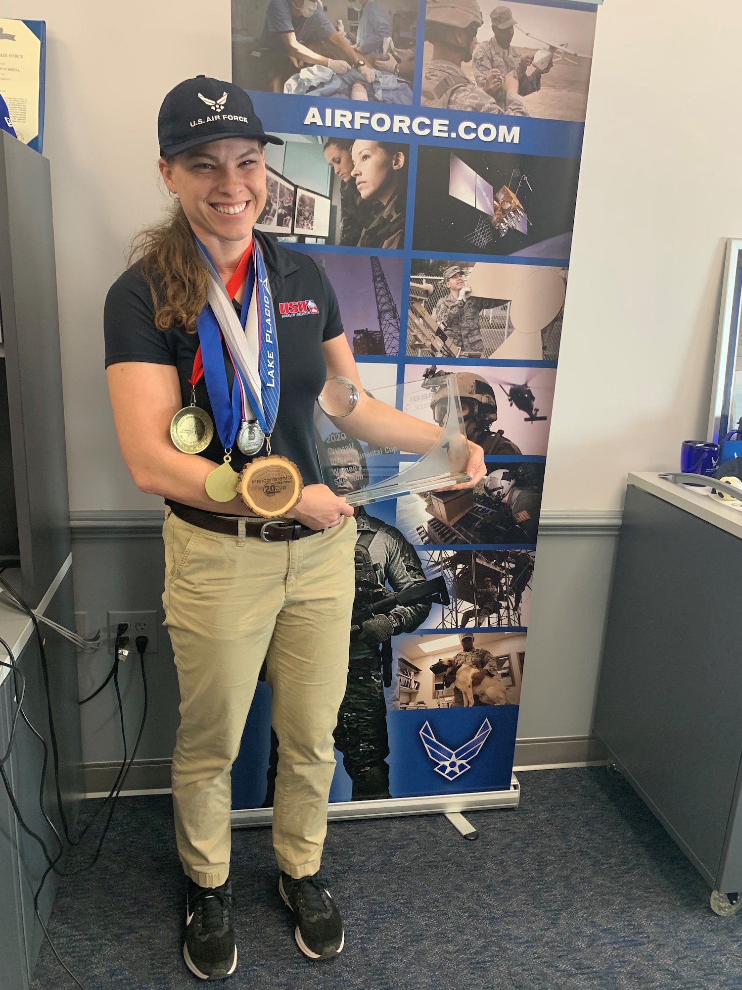 Airman 1st Class Kelly Curtis shows off some of her medals from competing as a member of USA skeleton team.