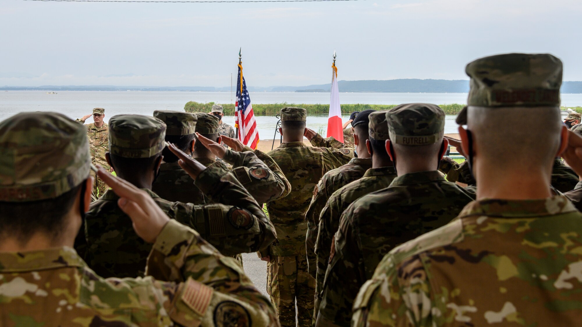 A group of Airmen salute the flag during a 9/11 memorial ceremony at Misawa Air Base, Japan, Sept. 11, 2020. Through participation in these events, the attendees ensured each of the firefighters lost during 9/11 were honored and that the world knows that they will never forget. (U.S. Air Force photo by Airman 1st Class China M. Shock)