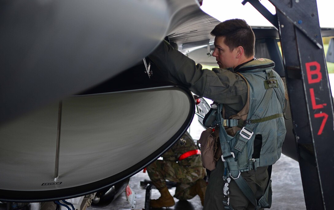 U.S. Air Force Capt. Daniel Simpson, an 18th Aggressor Squadron pilot, performs a pre-flight check before departing to support exercise Valiant Shield on Eielson Air Force Base, Alaska, Sept. 8, 2020. Valiant Shield 20 provides an optimal training environment to increase readiness and joint interoperability. (U.S. Air Force photo by Staff Sgt. Sean Martin)