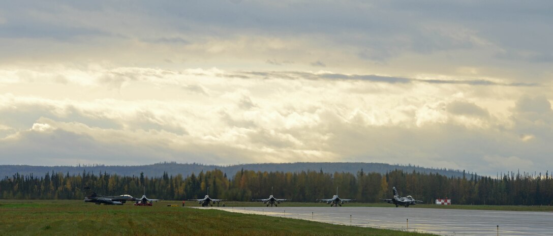 F-16 Fighting Falcons, assigned to the 18th Aggressor Squadron prepare to takeoff in support of exercise Valiant Shield on Eielson Air Force Base, Alaska, Sept. 8, 2020. As experts in enemy tactics, techniques and procedures, the Aggressors' role is to replicate the enemy in the air to provide a realistic training environment. Valiant Shield 20 provides a unique opportunity for Pacific Air Force to train with other services, increasing their ability to work collaboratively should the need arise. (U.S. Air Force photo by Staff Sgt. Sean Martin)