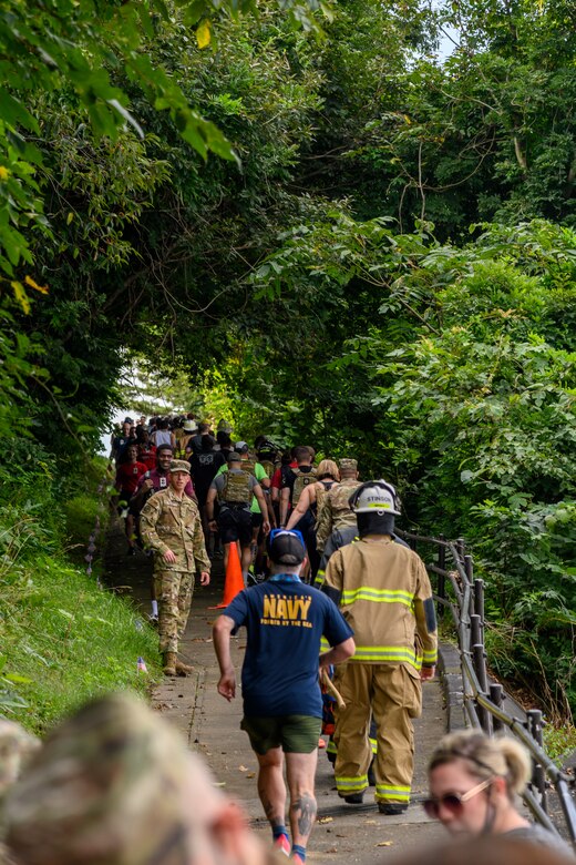 Team Misawa participants climb a hill at Misawa Air Base, Japan, Sept. 11, 2020. Each participant paid tribute to a New York City Fire Department firefighter by climbing or walking the equivalent of the 110 stories of the World Trade Center. Each individual tribute not only remembers the sacrifice of an FDNY firefighter but also symbolically represents their heroic journey to save others. (U.S. Air Force photo by Airman 1st Class China M. Shock)