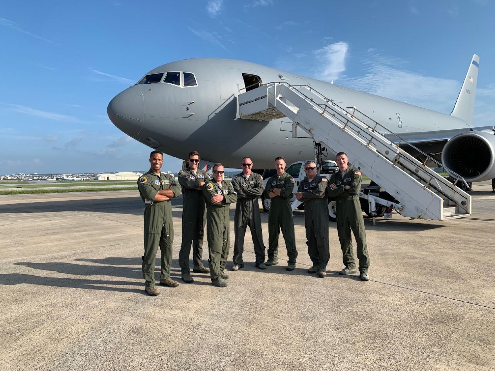 From left, Capt. Erik Earle, Capt. Chris Schimmel, Maj. Matt Valentino, Master Sgt. Brett Peterson, Capt. Jordan Gauvin, Chief Master Sgt. Michael George and Maj. Leon Rice pose in front of a KC-46A Pegasus, Sept. 8, 2020, at Kadena Air Base, Japan. The Pease airmen executed the first official transoceanic coronet ever accomplished with a Pegaus refueler, which began Sept. 9 and involved 16 aerial refuelings of five F/A-18 jets. (courtesy photo)