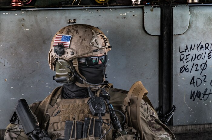 An explosive ordnance disposal technician, assigned to Commander, Task Force (CTF) 56, rides in an MH-60S Sea Hawk helicopter, attached to Helicopter Sea Combat Squadron (HSC) 26, after conducting fast-rope training in the Arabian Gulf.