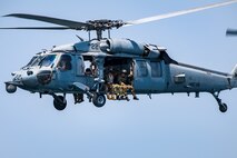 Explosive ordnance disposal technicians, assigned to Commander, Task Force (CTF) 56, ride in an MH-60S Sea Hawk helicopter, attached to Helicopter Sea Combat Squadron (HSC) 26, after conducting fast-rope training in the Arabian Gulf.