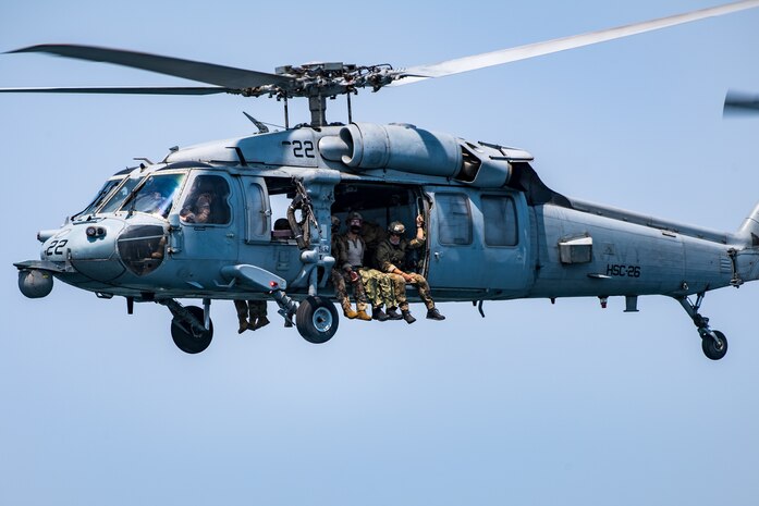 Explosive ordnance disposal technicians, assigned to Commander, Task Force (CTF) 56, ride in an MH-60S Sea Hawk helicopter, attached to Helicopter Sea Combat Squadron (HSC) 26, after conducting fast-rope training in the Arabian Gulf.