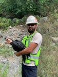 Chad Neil, a wildlife biologist for USDA APHIS Wildlife Services-West Virginia and part of the 167th AW’s Bird/Wildlife Aircraft Strike Hazard (BASH) team, holds a black vulture that has been fitted with a transmitting device in Martinsburg, W.Va., Aug. 18, 2020.