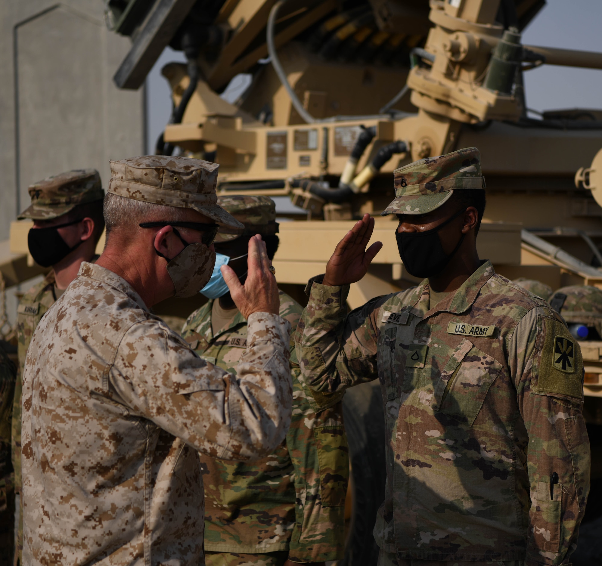 U.S. Marine Corps Gen. Kenneth F. McKenzie Jr., United States Central Command commander, salutes an Army Soldier during a visit to the Alpha Battery 5-52 Air Defense Artillery Battalion, Sept. 13, 2020, at Al Dhafra Air Base, United Arab Emirates.