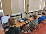 Students work on computers.