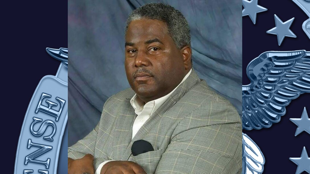 Al Hight in a grey suit with a blue background