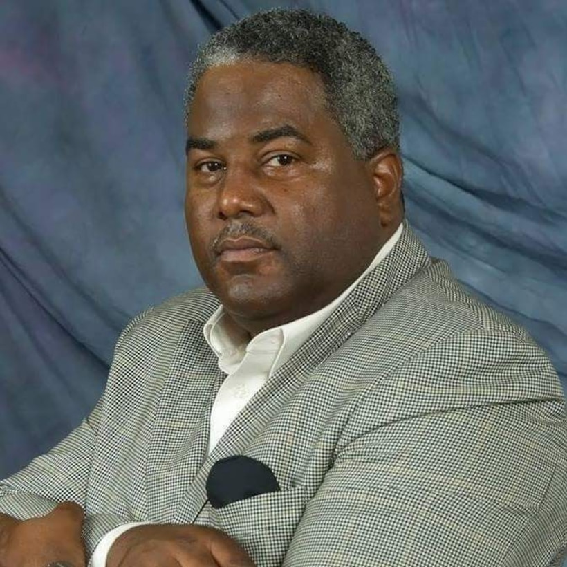 Al Hight in a grey suit with a blue background