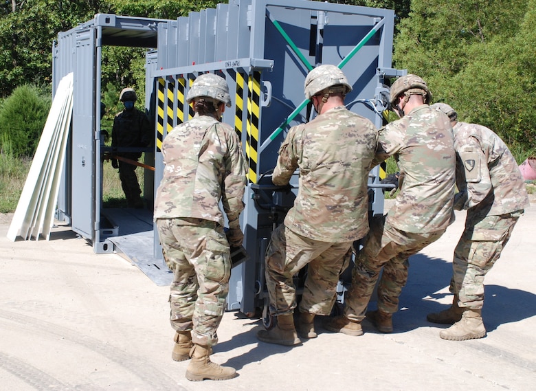 Soldiers from 5th Engineer Battalion extract the Ready Armor Protection for Instant Deployment, or RAPID, system from its storage container to secure the entrance way of Training Area 230 on Fort Leonard Wood, Mo., during the Maneuver Support, Sustainment and Protection Integration Experiments-2020 Aug. 17, 2020. Researchers from the U.S. Army Engineer Research and Development Center provided this protection technology to test and demonstrate the capability of the system and validate its performance.