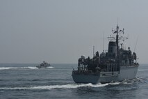 200910-A-FT904-1190 ARABIAN GULF (Sept. 10, 2020)  The Royal Navy Hunt-class mine countermeasures vessel HMS Chiddingfold (M37), right, sails in formation with a Mark VI patrol boat attached to Commander, Task Force (CTF) 56 during a bi-lateral mine countermeasure exercise between the U.K. and U.S. in the Arabian Gulf, Sept. 10.  CTF 56 is deployed to the U.S. 5th Fleet area of operations and conducts mine warfare operations in support of naval operations to ensure maritime stability in the Central Region, connecting the Mediterranean and Pacific through the Western Indian Ocean and three strategic chokepoints to the free flow of global commerce.  (U.S. Army photo by Staff Sgt. Timothy Clegg)