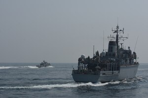 200910-A-FT904-1190 ARABIAN GULF (Sept. 10, 2020)  The Royal Navy Hunt-class mine countermeasures vessel HMS Chiddingfold (M37), right, sails in formation with a Mark VI patrol boat attached to Commander, Task Force (CTF) 56 during a bi-lateral mine countermeasure exercise between the U.K. and U.S. in the Arabian Gulf, Sept. 10.  CTF 56 is deployed to the U.S. 5th Fleet area of operations and conducts mine warfare operations in support of naval operations to ensure maritime stability in the Central Region, connecting the Mediterranean and Pacific through the Western Indian Ocean and three strategic chokepoints to the free flow of global commerce.  (U.S. Army photo by Staff Sgt. Timothy Clegg)