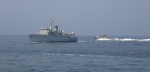 200910-A-HS292-1010 SOUTHERN ARABIAN GULF (Sept. 10, 2020) A Mark VI patrol boat attached to Commander, Task Force (CTF) 56 performs precision maneuvers with the Royal Navy Hunt-class mine countermeasures vessel HMS Chiddingfold (M37) during a bi-lateral mine countermeasure exercise between the U.K. and U.S. in the Arabian Gulf, Sept. 10. CTF 56 are deployed to the U.S. 5th Fleet area of operations in support of naval operations to ensure maritime stability and security in the Central Region, connecting the Mediterranean Sea and Pacific Ocean through the Western Indian Ocean and three strategic chokepoints to the free flow of global commerce. (U.S. Army photo by Spc. Tradale Bryant)