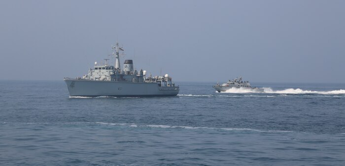 200910-A-HS292-1010 SOUTHERN ARABIAN GULF (Sept. 10, 2020) A Mark VI patrol boat attached to Commander, Task Force (CTF) 56 performs precision maneuvers with the Royal Navy Hunt-class mine countermeasures vessel HMS Chiddingfold (M37) during a bi-lateral mine countermeasure exercise between the U.K. and U.S. in the Arabian Gulf, Sept. 10. CTF 56 are deployed to the U.S. 5th Fleet area of operations in support of naval operations to ensure maritime stability and security in the Central Region, connecting the Mediterranean Sea and Pacific Ocean through the Western Indian Ocean and three strategic chokepoints to the free flow of global commerce. (U.S. Army photo by Spc. Tradale Bryant)