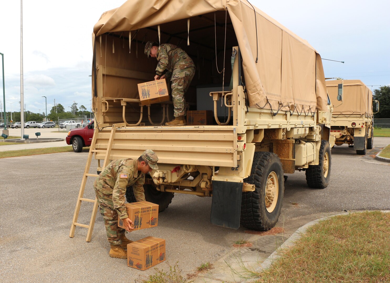 Mississippi National Guard Spc. Jan Lao and Pfc. Mckenzie Smith of the 890th Engineer Battalion load supplies onto a Light Medium Tactical Vehicle in Gulfport, Miss., Sep. 14, 2020. The Soldiers will be part of a 10-person team on standby to rescue residents from flooded areas due to Hurricane Sally.