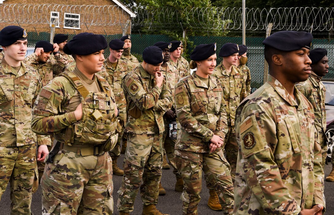 Members From the 100th Security Forces Squadron stand in formation before starting the remembrance walk at Royal Air Force Mildenhall, England, Sept. 11, 2020.