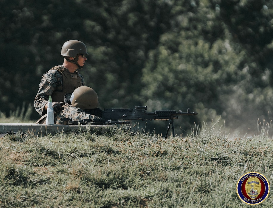 Sgt Larue observes impacts on target as he coaches a Military Police student on employing the M-240 machine gun.