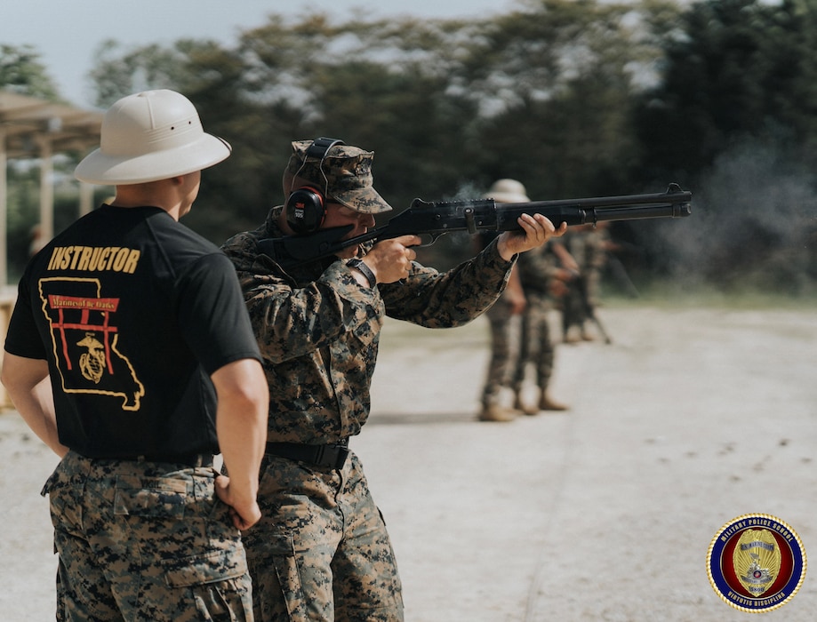SSgt Vigil coaches a Military student on the proper employment of the M1014 Shotgun.