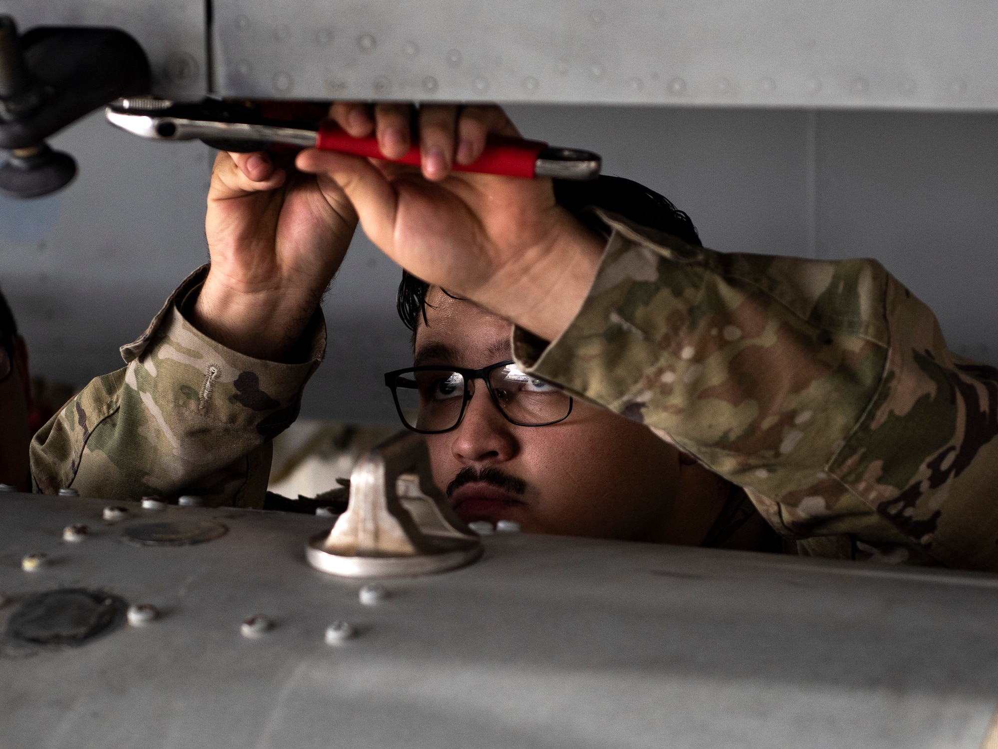 A U.S. Air Force Airman, assigned to the 48th Component Maintenance Squadron fuels systems maintenance shop, works to attach an external fuel tank to an F-15C Eagle during an Agile Combat Employment training at Royal Air Force Lakenheath, England, Aug. 31, 2020. The training was designed to enhance ACE  capabilities by teaching Airmen to perform multiple roles outside the scope of their regular daily duties. (U.S. Air Force photo by Airman 1st Class Jessi Monte)