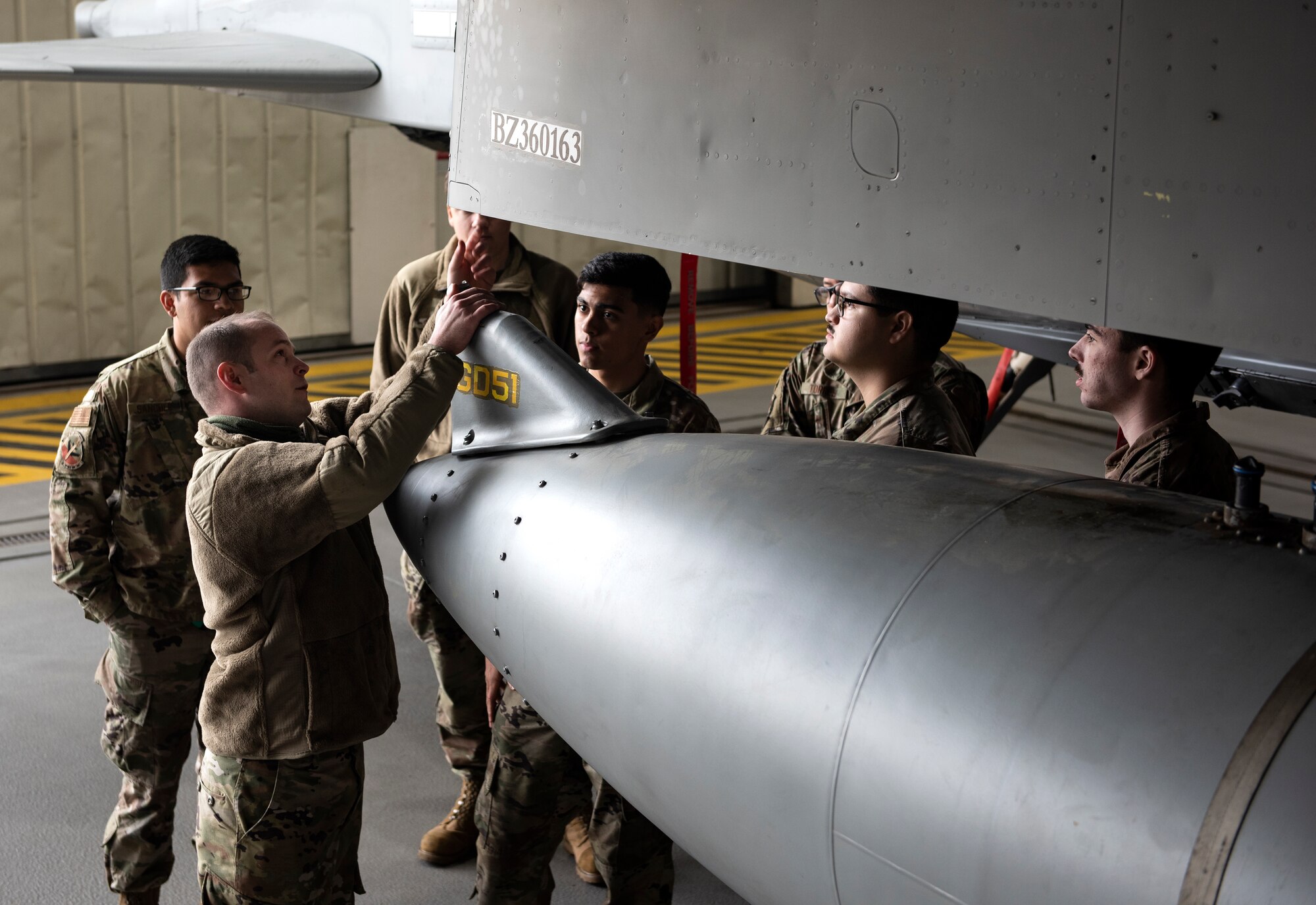 U.S. Air Force Airmen, assigned to the 48th Component Maintenance Squadron fuels systems maintenance shop, learn how to attach an external fuel tank to an F-15C Eagle during an Agile Combat Employment training at Royal Air Force Lakenheath, England, Aug. 31, 2020. The training was designed to enhance ACE  capabilities by teaching Airmen to perform multiple roles outside the scope of their regular daily duties. (U.S. Air Force photo by Airman 1st Class Jessi Monte)