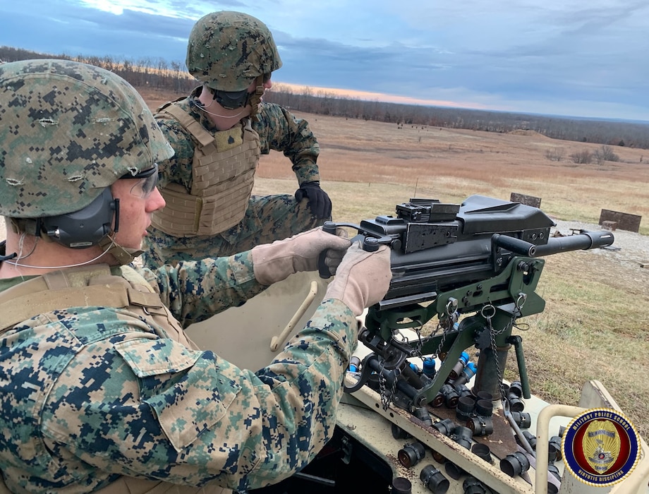 Sgt White observes impacts on target as he coaches a Military student on the proper employment of the MK-19 grenade launcher.